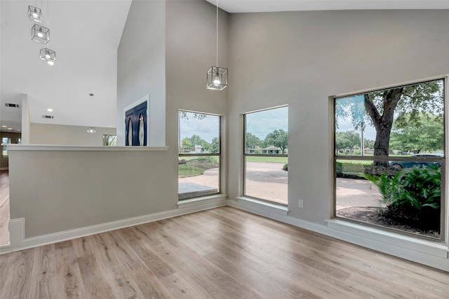 interior space featuring light hardwood / wood-style flooring and high vaulted ceiling