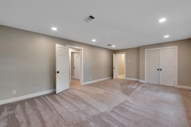 unfurnished room featuring light carpet