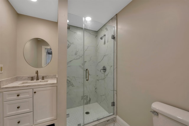 bathroom with walk in shower, vanity, and toilet