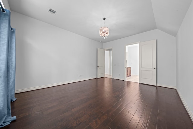 unfurnished bedroom featuring a notable chandelier, dark hardwood / wood-style flooring, and vaulted ceiling