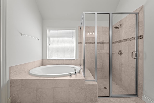 bathroom featuring lofted ceiling and independent shower and bath