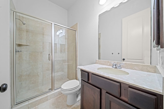 bathroom featuring tile patterned flooring, vanity, toilet, and walk in shower