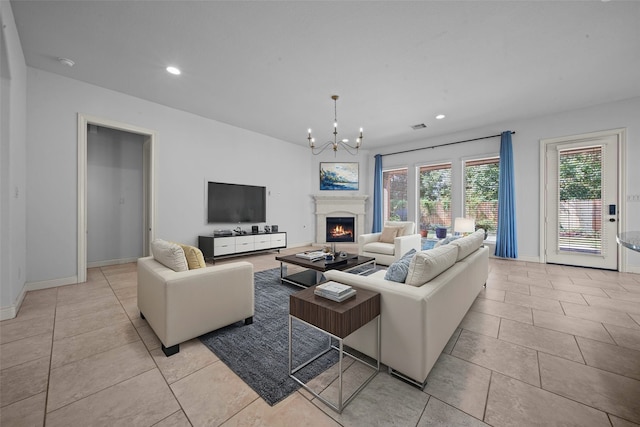 living room featuring light tile patterned flooring and an inviting chandelier