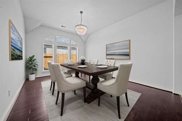 dining area featuring a chandelier, dark hardwood / wood-style floors, and vaulted ceiling