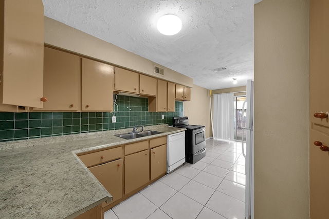 kitchen with a textured ceiling, tasteful backsplash, sink, white appliances, and light tile patterned floors