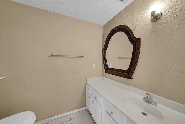 bathroom featuring vanity, toilet, and tile patterned floors