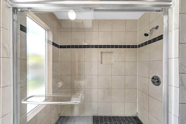 bathroom featuring a shower with shower door