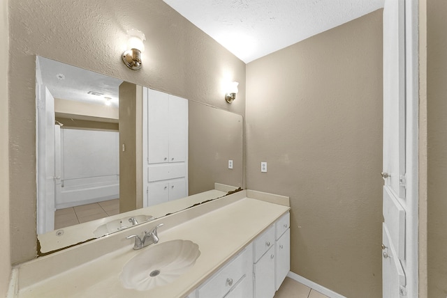 bathroom with vanity, tile patterned flooring, and a textured ceiling