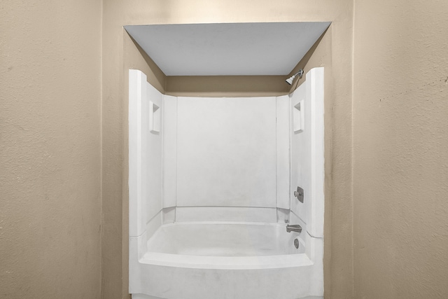 bathroom with washtub / shower combination