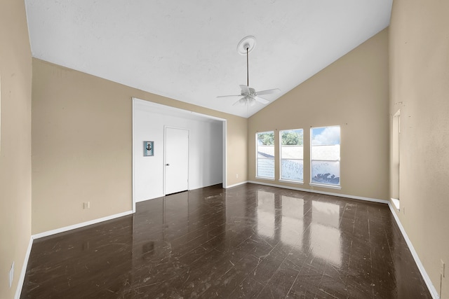 empty room with dark hardwood / wood-style flooring, ceiling fan, and high vaulted ceiling