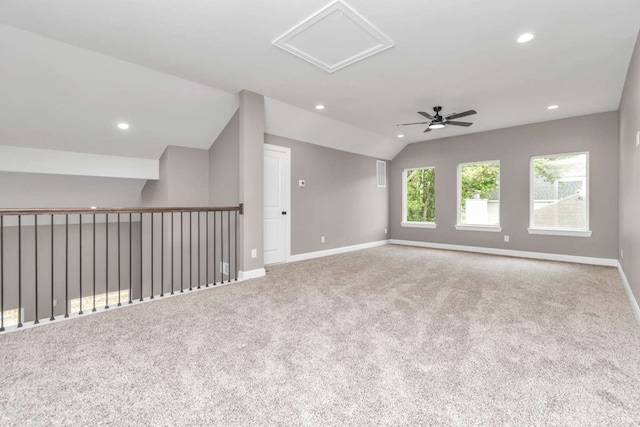 spare room featuring lofted ceiling, ceiling fan, and light carpet