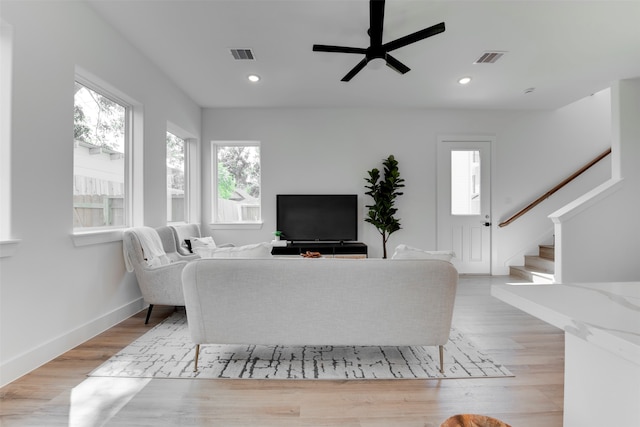 living room with light wood-type flooring and ceiling fan