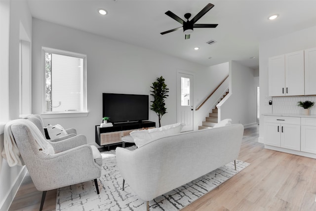 living room featuring ceiling fan, a healthy amount of sunlight, and light hardwood / wood-style floors