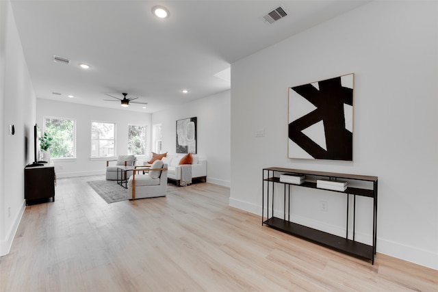 living room with ceiling fan and light hardwood / wood-style floors