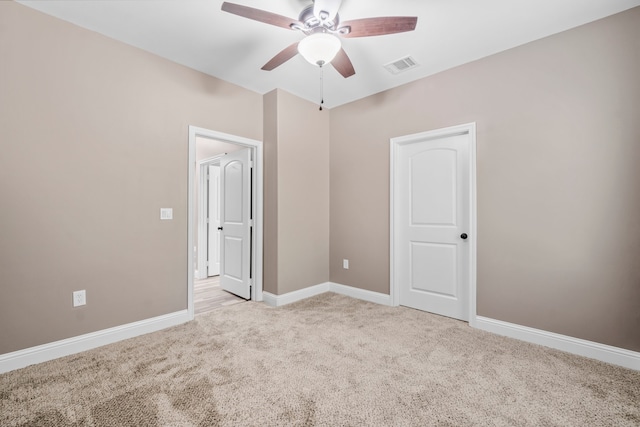 unfurnished bedroom featuring light carpet and ceiling fan