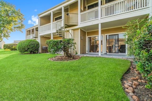 exterior space with a balcony and a yard