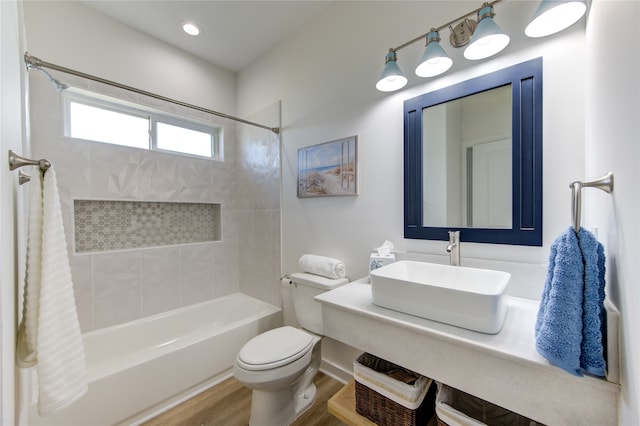 full bathroom featuring toilet, shower / bath combo with shower curtain, sink, and hardwood / wood-style flooring