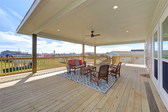 wooden deck featuring ceiling fan and outdoor lounge area