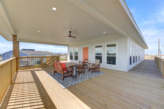 wooden terrace featuring ceiling fan