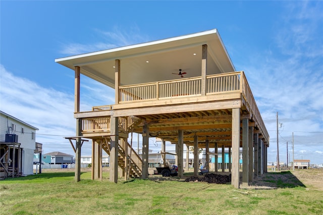 rear view of property with central air condition unit, ceiling fan, a deck, and a yard