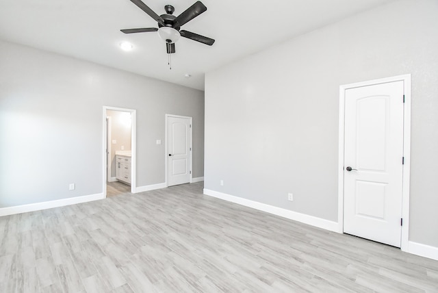 unfurnished bedroom featuring light hardwood / wood-style flooring, ensuite bathroom, and ceiling fan