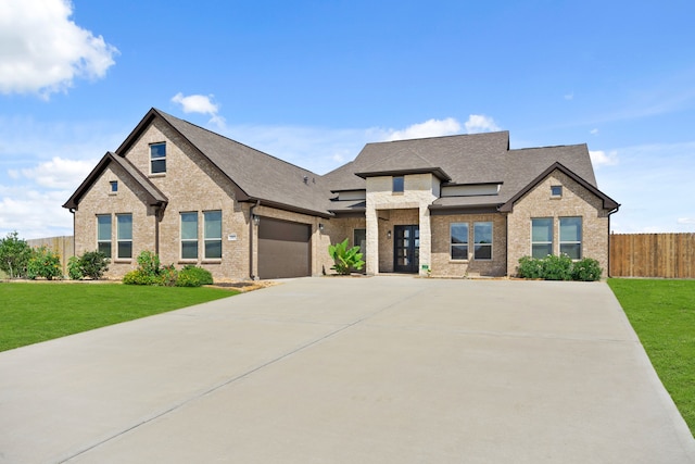 view of front of property with a front lawn and a garage