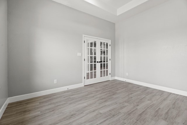 unfurnished room featuring french doors and light hardwood / wood-style floors