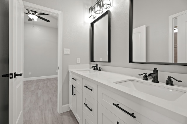 bathroom with vanity, hardwood / wood-style floors, and ceiling fan