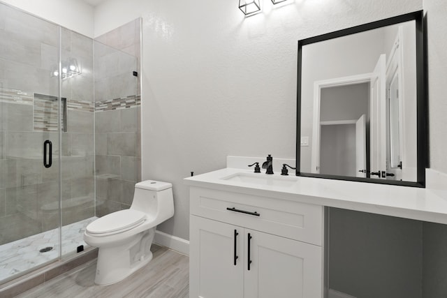 bathroom with vanity, hardwood / wood-style flooring, toilet, and walk in shower