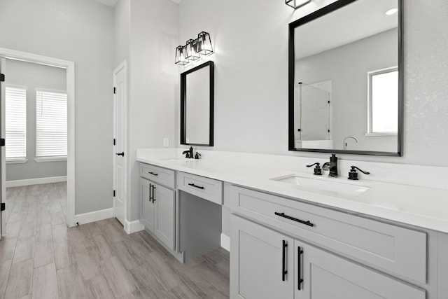 bathroom with vanity, wood-type flooring, and walk in shower