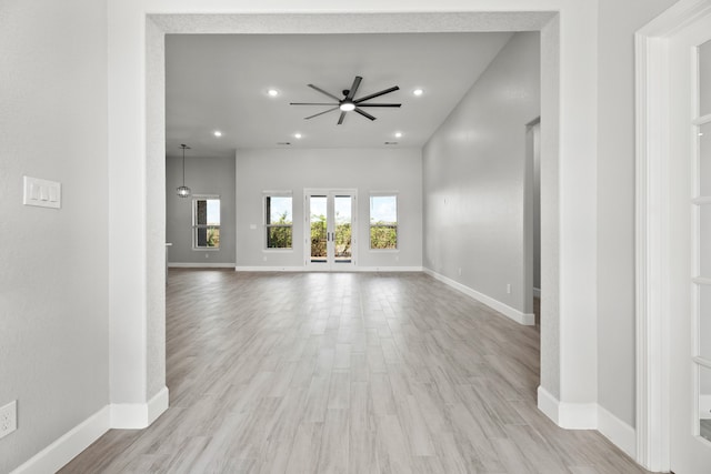 unfurnished living room with light hardwood / wood-style flooring and ceiling fan