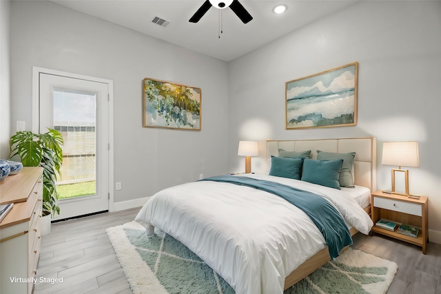 bedroom with light hardwood / wood-style flooring and ceiling fan