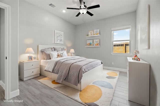 bedroom featuring light hardwood / wood-style flooring and ceiling fan