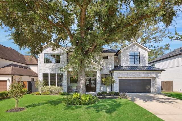 view of front of house with a front lawn and a garage