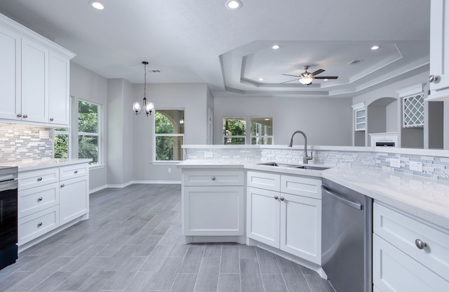 kitchen featuring stainless steel appliances, white cabinetry, a healthy amount of sunlight, and sink