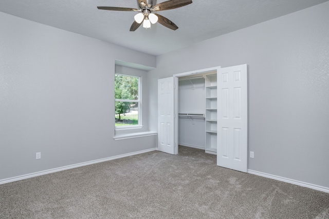 unfurnished bedroom with a closet, carpet, and ceiling fan