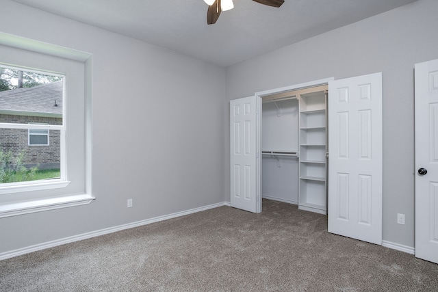 unfurnished bedroom featuring ceiling fan, a closet, carpet flooring, and multiple windows