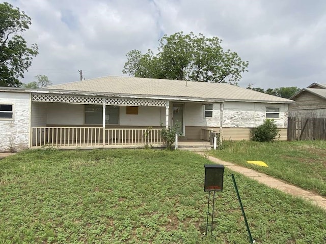 back of house with a porch and a lawn