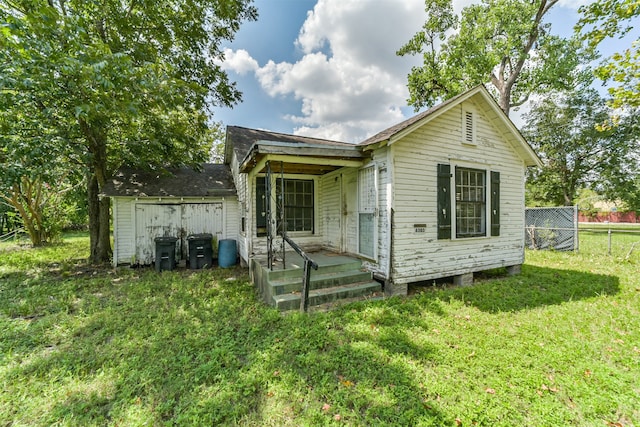 rear view of house with a yard