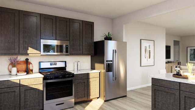 kitchen featuring dark brown cabinets, appliances with stainless steel finishes, and light wood-type flooring