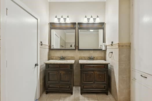 bathroom with tile walls, vanity, and tile patterned floors