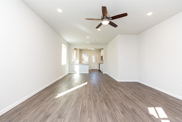 unfurnished living room featuring hardwood / wood-style floors and ceiling fan