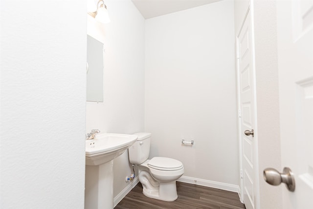 bathroom with wood-type flooring and toilet