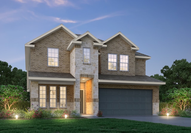 view of front of property with a lawn and a garage