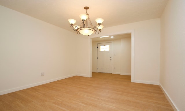 interior space with an inviting chandelier and light wood-type flooring