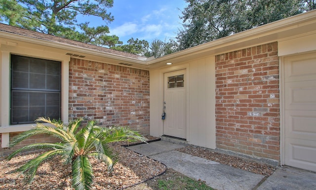 doorway to property featuring a garage