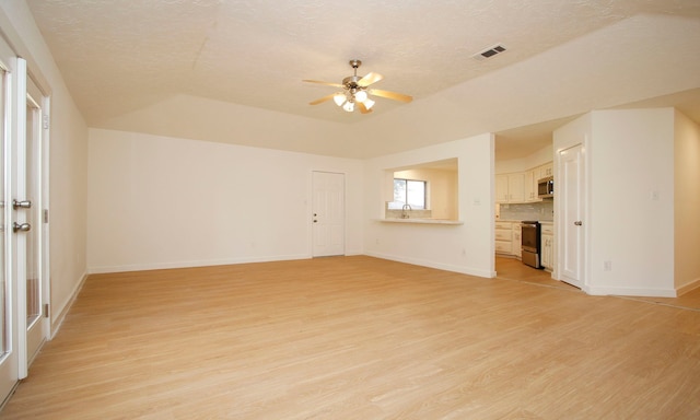 unfurnished living room with ceiling fan, a textured ceiling, and light wood-type flooring