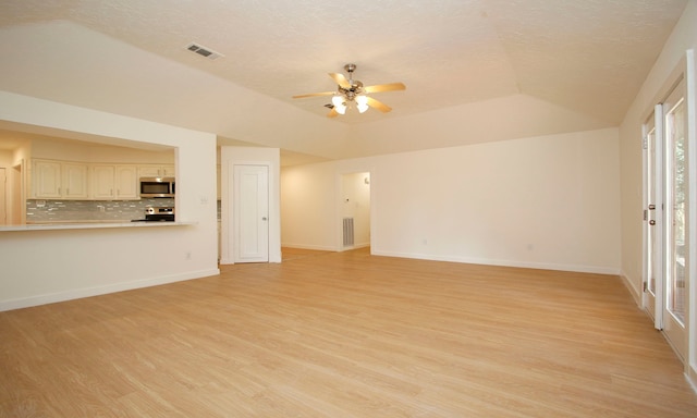 unfurnished living room featuring light wood-type flooring, a textured ceiling, and ceiling fan