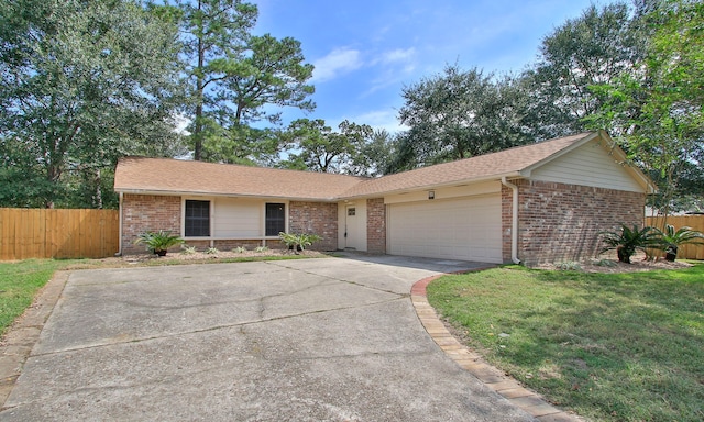 ranch-style home featuring a garage and a front lawn