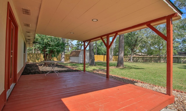 deck featuring a lawn and a shed